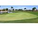 Lush golf course with smooth greens and a scenic water feature, perfect for a relaxing game at 4081 N 156Th Dr, Goodyear, AZ 85395