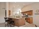 Open kitchen features granite countertops, breakfast bar, and ample cabinet space at 4081 N 156Th Dr, Goodyear, AZ 85395