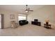 Spacious living room featuring a ceiling fan and a large window, providing ample natural light at 4081 N 156Th Dr, Goodyear, AZ 85395