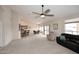 Spacious living room with a ceiling fan, access to the dining area, and lots of light at 4081 N 156Th Dr, Goodyear, AZ 85395