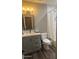 Updated bathroom featuring a modern vanity, mirror, toilet and shower/tub combo at 5211 W Beryl Ave, Glendale, AZ 85302