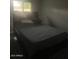 Bedding is on a bed frame in this carpeted bedroom with overhead lighting at 5211 W Beryl Ave, Glendale, AZ 85302