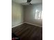 Bright bedroom with wood-look floors and a sliding glass door to the backyard patio at 5211 W Beryl Ave, Glendale, AZ 85302
