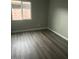This bedroom with wood-look floors and neutral walls offers a comfortable space for rest and relaxation at 5211 W Beryl Ave, Glendale, AZ 85302