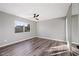 Bedroom features hardwood floors, ceiling fan and mirrored closet sliding doors at 5211 W Beryl Ave, Glendale, AZ 85302