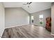 Open living room with vaulted ceilings, ceiling fan, and large windows providing plenty of light at 5211 W Beryl Ave, Glendale, AZ 85302