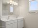 Bright bathroom with double vanity, large mirror, and natural lighting from a sunny window at 5812 E Freesia Ln, San Tan Valley, AZ 85140