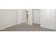 Bedroom with carpeted floor, white doors and access to kitchen at 5812 E Freesia Ln, San Tan Valley, AZ 85140