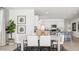 Open dining and kitchen area with eat-in island, modern lighting and stainless appliances at 5812 E Freesia Ln, San Tan Valley, AZ 85140