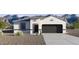 Charming single-story home with desert landscaping and a two-car garage, set against a backdrop of mountains at 5812 E Freesia Ln, San Tan Valley, AZ 85140