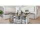 Bright kitchen with a central island, granite countertops, stainless steel appliances, and sleek white cabinetry at 5812 E Freesia Ln, San Tan Valley, AZ 85140