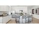 Stylish kitchen island with seating, granite countertops, stainless steel appliances, and sleek white cabinetry at 5812 E Freesia Ln, San Tan Valley, AZ 85140