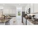 Well-equipped kitchen features granite countertops, stainless steel appliances, ample cabinet space, and a modern design at 5812 E Freesia Ln, San Tan Valley, AZ 85140