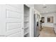Pantry and stainless steel refrigerator in the kitchen with granite countertops and lots of storage space at 5812 E Freesia Ln, San Tan Valley, AZ 85140