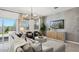 Elegant living room features stylish furnishings, a modern light fixture, and a sliding glass door to the patio at 5812 E Freesia Ln, San Tan Valley, AZ 85140