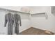 Organized walk-in closet with shelving, hanging rods and plush carpeting at 5812 E Freesia Ln, San Tan Valley, AZ 85140