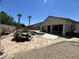 Landscaped backyard with pool, dining set on stone patio, covered patio area, and desert landscaping at 7326 W Dreyfus Dr, Peoria, AZ 85381