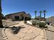 Backyard view featuring a custom pool area, palm trees, and mature desert landscaping at 7326 W Dreyfus Dr, Peoria, AZ 85381