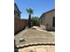 Backyard view with rock landscaping and a privacy wall showcasing desert climate design at 7326 W Dreyfus Dr, Peoria, AZ 85381