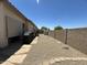 Wide view of the backyard showcasing desert landscaping, rock features, and a block fence for privacy at 7326 W Dreyfus Dr, Peoria, AZ 85381