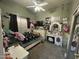 This bedroom includes a ceiling fan, a tv, and a white vanity at 7326 W Dreyfus Dr, Peoria, AZ 85381