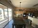 Bright dining area featuring modern lighting, tile floors, and direct access to the backyard at 7326 W Dreyfus Dr, Peoria, AZ 85381