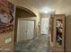 Inviting foyer with tile floors, closet storage, and elegant display cabinet at 7326 W Dreyfus Dr, Peoria, AZ 85381