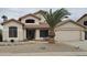 Charming two-story home with well-kept landscaping, desert rock, and a prominent palm tree in the front yard at 7326 W Dreyfus Dr, Peoria, AZ 85381