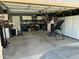 Wide garage view with storage cabinets, tools, a hanging bike rack, and room for parking vehicles and storage at 7326 W Dreyfus Dr, Peoria, AZ 85381