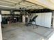Spacious garage area with ample storage cabinets, tools, and accessories, with visible ceiling mounted bike storage at 7326 W Dreyfus Dr, Peoria, AZ 85381