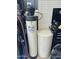 Garage view of water softener unit with nearby air compressor and tool chest inside well lit space at 7326 W Dreyfus Dr, Peoria, AZ 85381