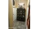 Hallway featuring tile flooring, display cabinet, and wine themed artwork at 7326 W Dreyfus Dr, Peoria, AZ 85381