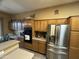 Eat-in kitchen boasts stainless steel appliances and abundant wood cabinets for ample storage space at 7326 W Dreyfus Dr, Peoria, AZ 85381