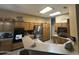 Spacious eat-in kitchen with stainless steel fridge, wood cabinets, and breakfast bar, perfect for entertaining at 7326 W Dreyfus Dr, Peoria, AZ 85381