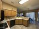 Open kitchen featuring wood cabinets, stainless steel sink, and breakfast bar for casual dining at 7326 W Dreyfus Dr, Peoria, AZ 85381