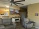 Open-concept living room with tile flooring, comfortable seating, and easy access to the kitchen at 7326 W Dreyfus Dr, Peoria, AZ 85381