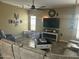 Comfortable living room with tile floors, neutral walls, ceiling fan, and modern entertainment center at 7326 W Dreyfus Dr, Peoria, AZ 85381