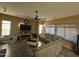 Cozy living room with tile flooring, ceiling fan, and a plush sectional sofa at 7326 W Dreyfus Dr, Peoria, AZ 85381