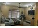 Bedroom boasts a king-sized bed, ceiling fan, workspace, and great natural light from a window at 7326 W Dreyfus Dr, Peoria, AZ 85381