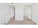 A bedroom featuring neutral carpet and mirrored closet at 7844 E Rovey Ave, Scottsdale, AZ 85250