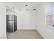 Bright dining area with a stainless steel refrigerator and lots of natural light at 7844 E Rovey Ave, Scottsdale, AZ 85250