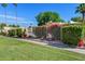 Community fence and flowers behind green grass at 7844 E Rovey Ave, Scottsdale, AZ 85250