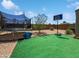 Spacious backyard featuring grass, a trampoline, and a basketball hoop for entertainment at 1237 E Paul Dr, Casa Grande, AZ 85122