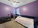 Purple bedroom featuring a single bed, carpet, and window with natural light at 1237 E Paul Dr, Casa Grande, AZ 85122