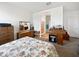 Bedroom featuring carpet floors, floral bedding, desk, and access to the en-suite bathroom at 1237 E Paul Dr, Casa Grande, AZ 85122
