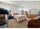 Bright bedroom featuring wood furniture, carpeted floors, and ample natural light at 1237 E Paul Dr, Casa Grande, AZ 85122