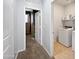 Bright hallway showcases neutral paint, carpet floors, and laundry area with white washer and dryer at 1237 E Paul Dr, Casa Grande, AZ 85122