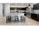 Bright kitchen boasts an island with seating and modern appliances for cooking convenience at 1237 E Paul Dr, Casa Grande, AZ 85122
