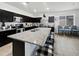 Spacious kitchen island with granite countertops and seating overlooks stainless steel appliances at 1237 E Paul Dr, Casa Grande, AZ 85122