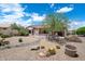 Desert landscaped backyard with a covered patio providing a relaxing outdoor living space at 15313 W Pantano Dr, Surprise, AZ 85374
